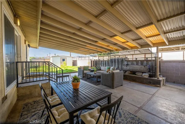 a view of a patio with a table and chairs
