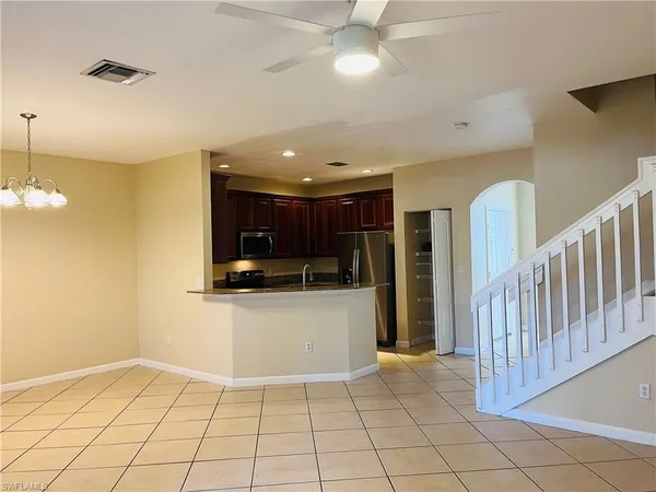 a view of kitchen with refrigerator and microwave