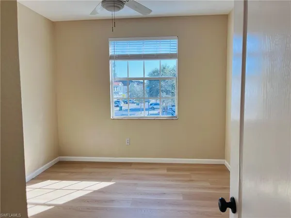 a view of a room with wooden floor and window