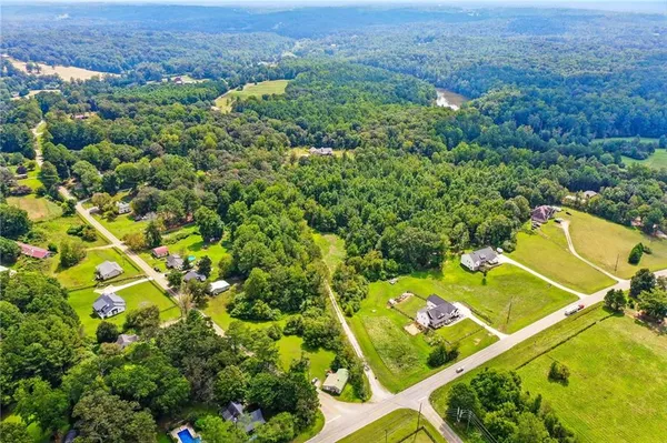 an aerial view of a residential houses with a green space