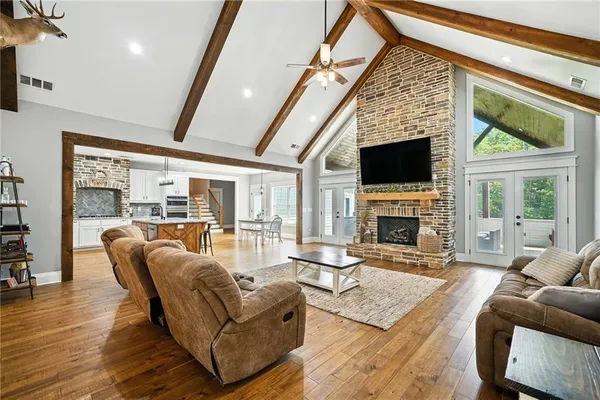 a living room with furniture a flat screen tv and a fireplace