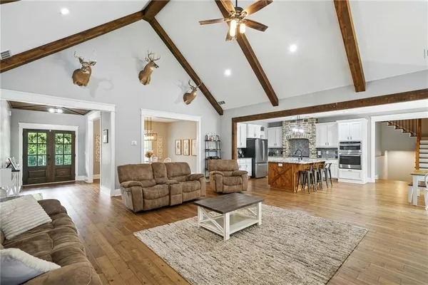 a living room with furniture and wooden floor