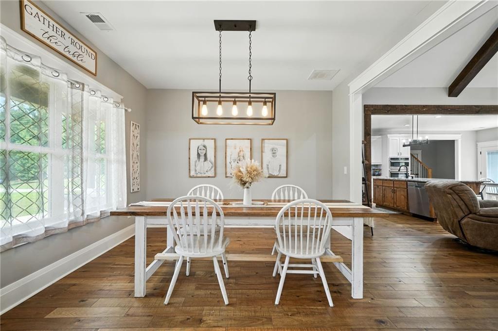 14430 Fincher Road Ball Ground, GA 30107 - Photo 20 of 51 a view of a dining room with furniture window and wooden floor