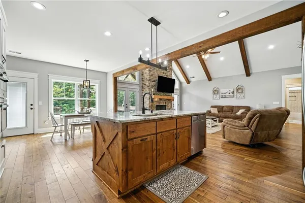 a large kitchen with a table and chairs