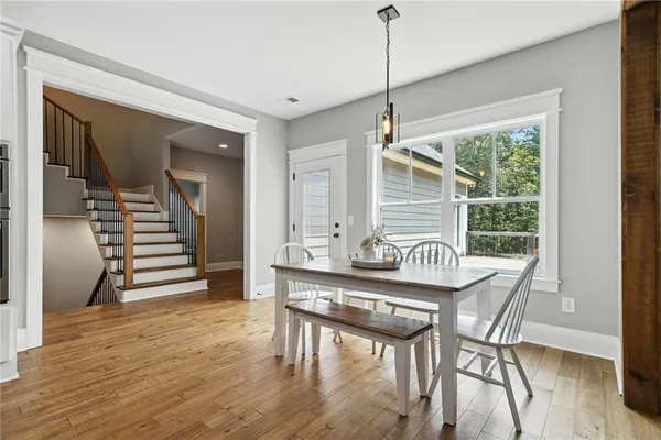 a view of a dining room with furniture window and wooden floor