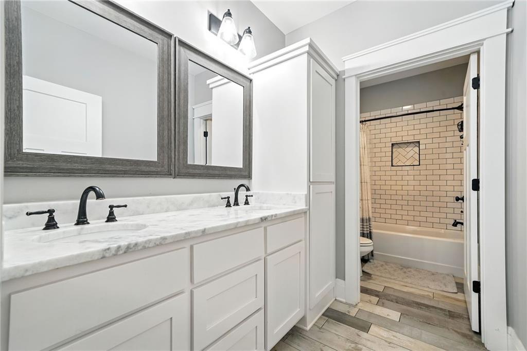 14430 Fincher Road Ball Ground, GA 30107 - Photo 29 of 51 a bathroom with a double vanity sink a mirror and a shower
