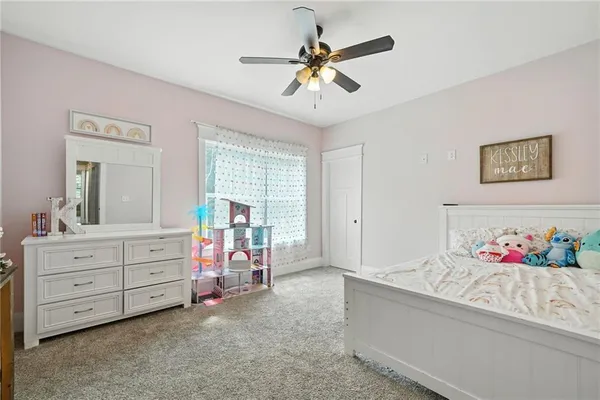 a bedroom with a bed a window and a flat screen television