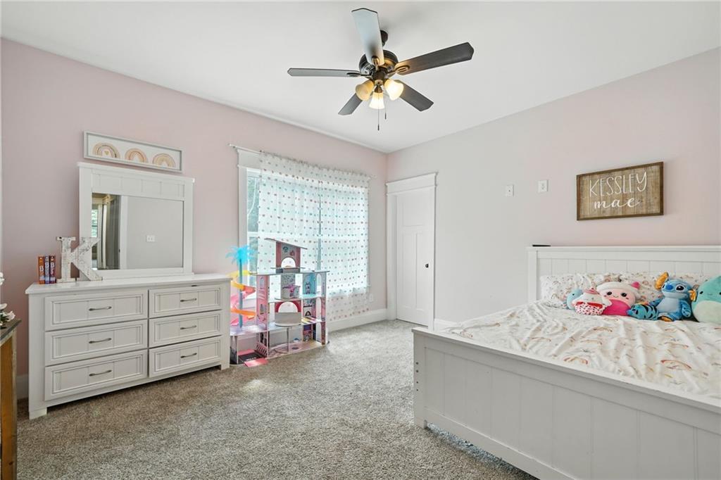14430 Fincher Road Ball Ground, GA 30107 - Photo 30 of 51 a bed room with a bed and a chandelier