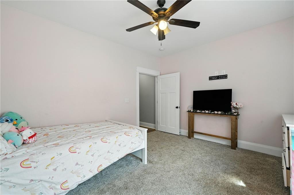 14430 Fincher Road Ball Ground, GA 30107 - Photo 31 of 51 a bedroom with a bed and a flat screen tv