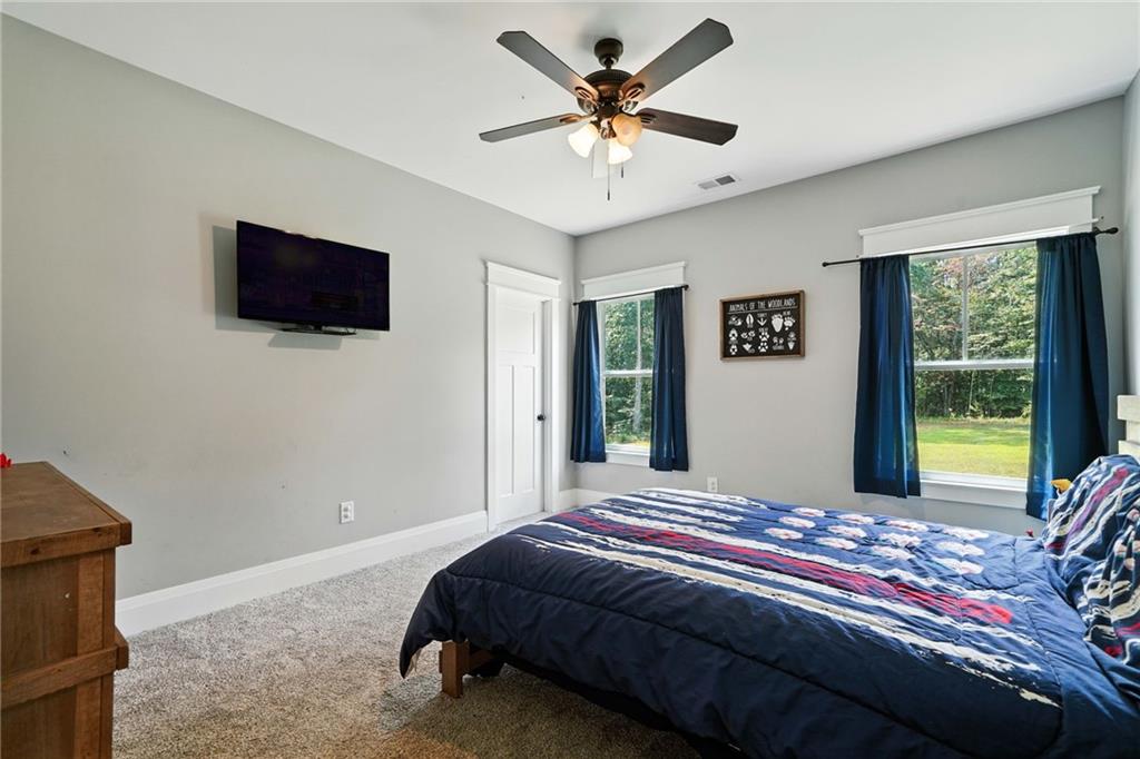 14430 Fincher Road Ball Ground, GA 30107 - Photo 32 of 51 a bedroom with a bed a window and a flat screen television