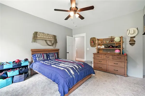 a bathroom with a toilet sink vanity and mirror
