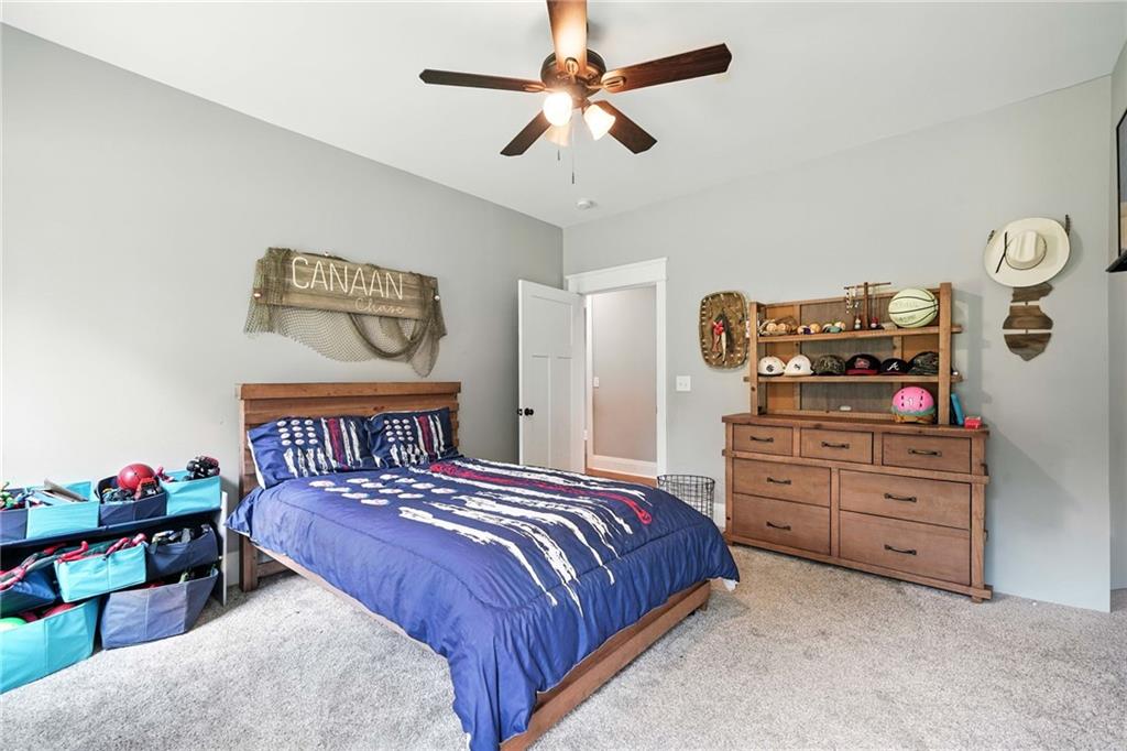 14430 Fincher Road Ball Ground, GA 30107 - Photo 33 of 51 a bedroom with a bed and a chandelier
