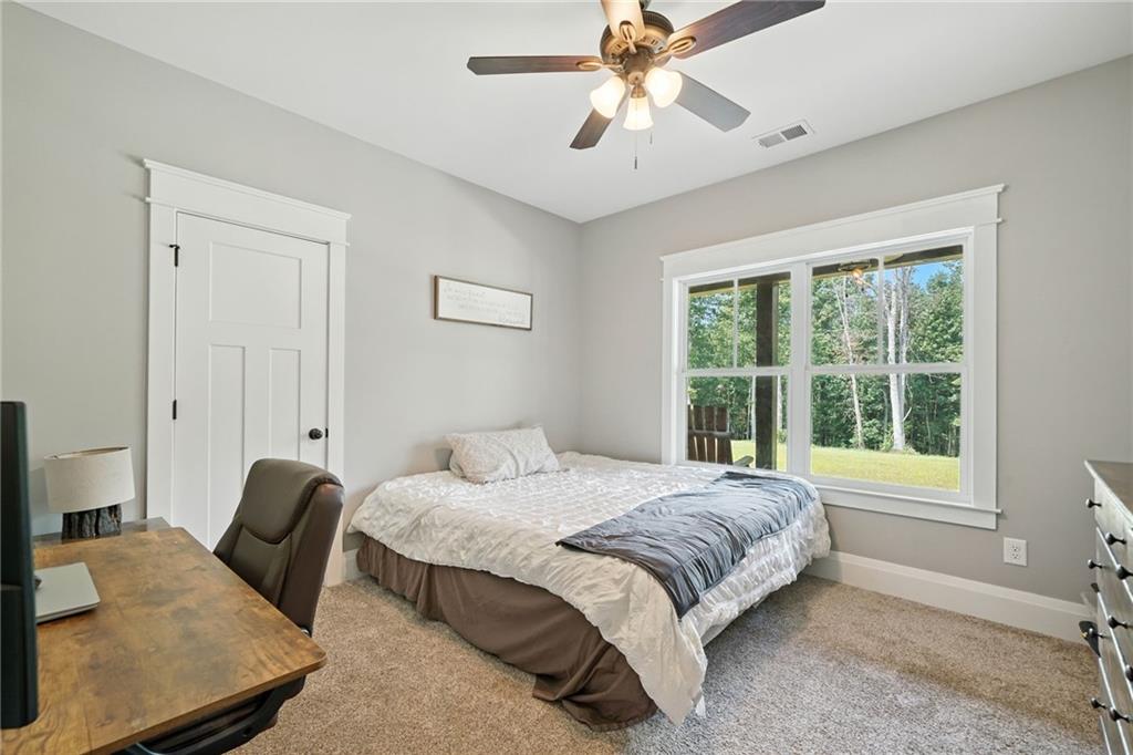 14430 Fincher Road Ball Ground, GA 30107 - Photo 34 of 51 a bedroom with a bed and wooden floor