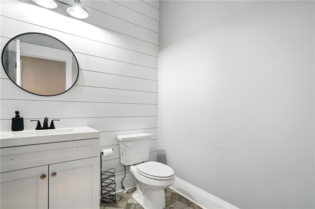 14430 Fincher Road Ball Ground, GA 30107 - Photo 35 of 51 a bathroom with a toilet sink vanity and mirror