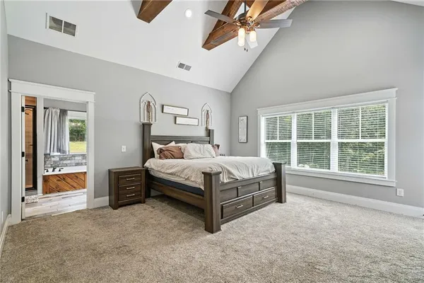 a bedroom with a bed and a television