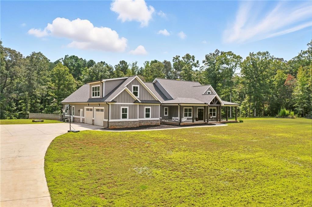 14430 Fincher Road Ball Ground, GA 30107 - Photo 4 of 51 a front view of a house with a garden