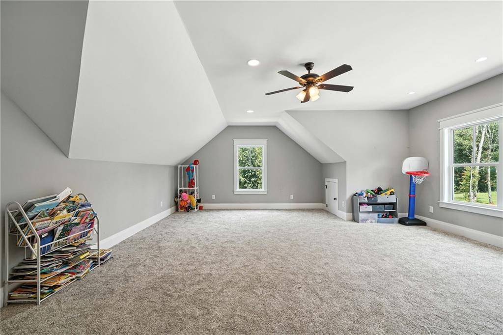 14430 Fincher Road Ball Ground, GA 30107 - Photo 45 of 51 an empty room with windows and ceiling fan