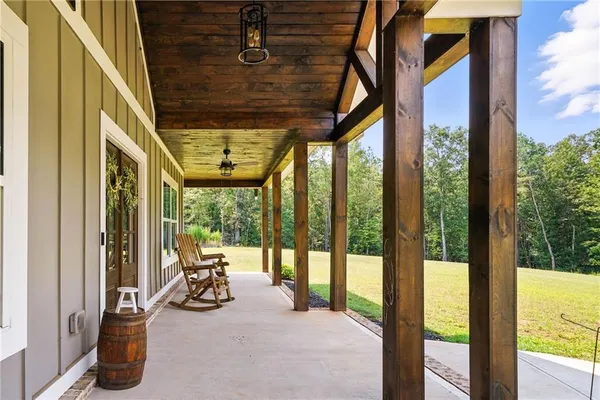 a view of a room with furniture wooden floor and windows