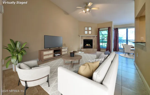 a living room with fireplace furniture and a flat screen tv