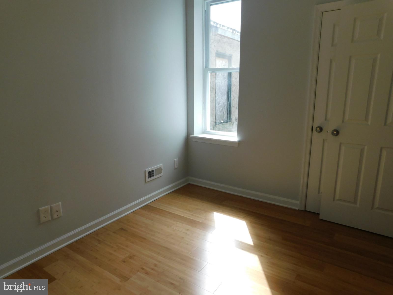 2238 Master Street Philadelphia, PA 19121 - Photo 13 of 24 an empty room with wooden floor and windows