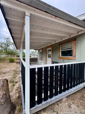 a view of a house with backyard porch and wooden floor