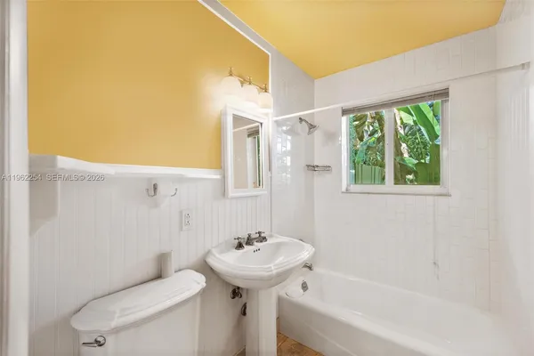 a bathroom with a sink a toilet and tub