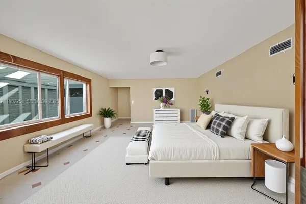 a bedroom with furniture and windows