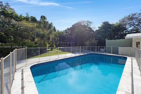 a view of a swimming pool with a yard and mountain view