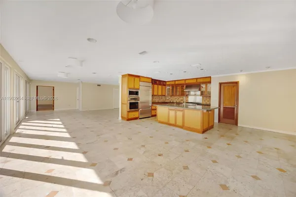 a view of a livingroom with kitchen and furniture