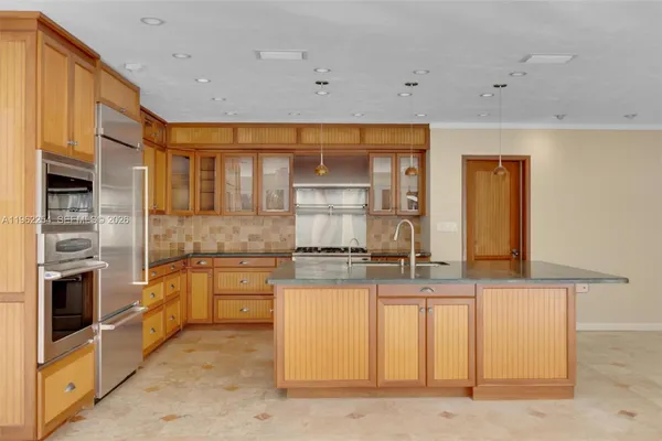 a kitchen with stainless steel appliances granite countertop a stove and a sink