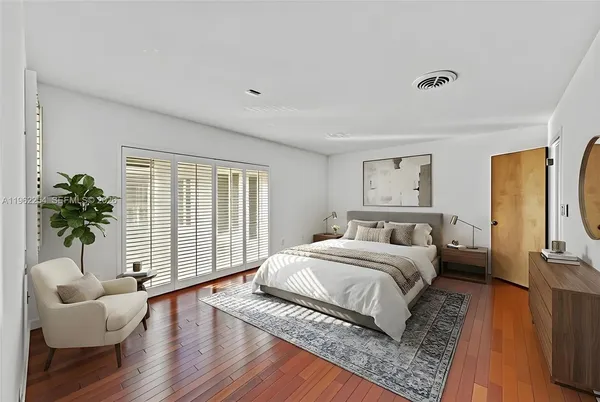 a bedroom with a bed and a couch