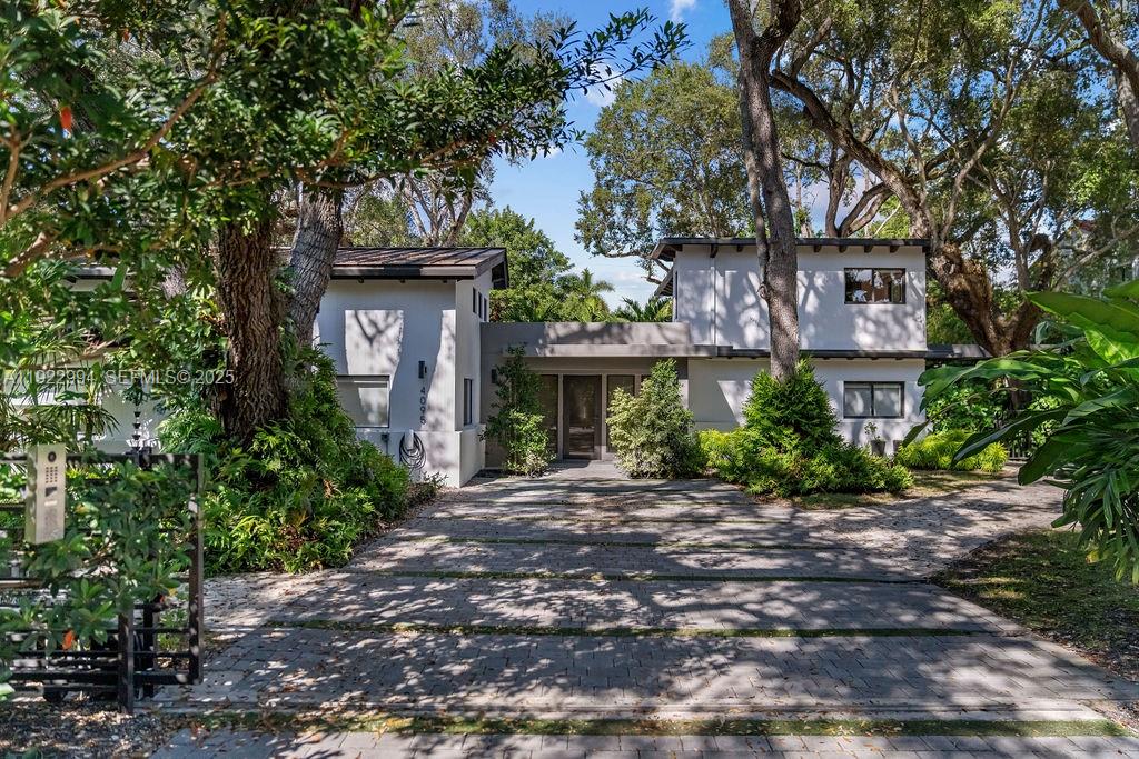 4095 Battersea Road Miami, FL 33133 - Photo 1 of 82 a front view of a house with a garden