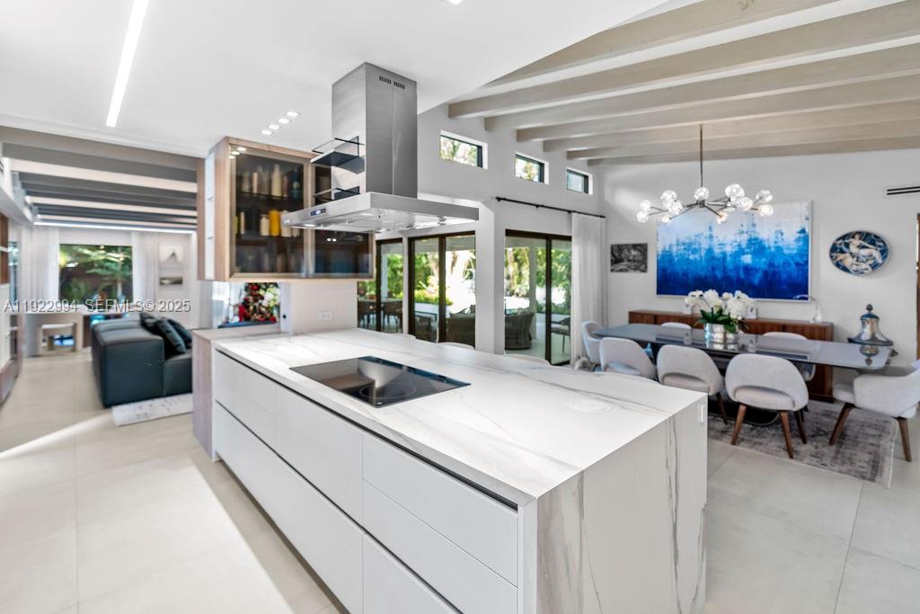 4095 Battersea Road Miami, FL 33133 - Photo 11 of 82 a kitchen that has a lot of cabinets in it