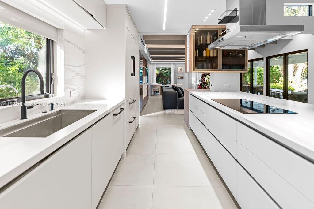 4095 Battersea Road Miami, FL 33133 - Photo 12 of 82 a kitchen with stainless steel appliances granite countertop a sink and a stove