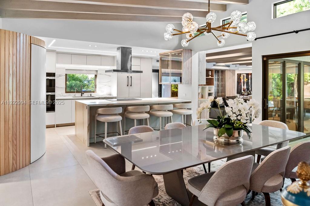 4095 Battersea Road Miami, FL 33133 - Photo 4 of 82 a view of a dining room with furniture and a chandelier