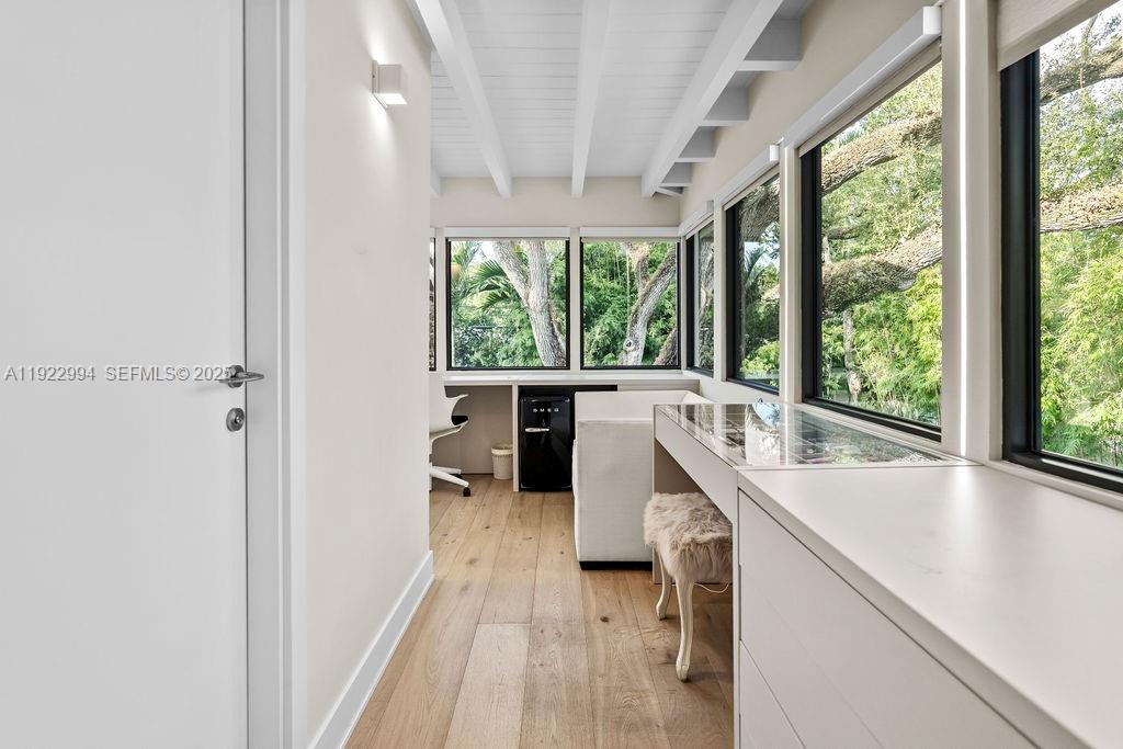 4095 Battersea Road Miami, FL 33133 - Photo 76 of 82 a kitchen with a large window a sink and cabinets