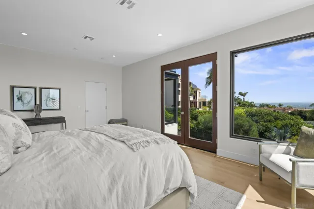 a bedroom with a bed and a mirror