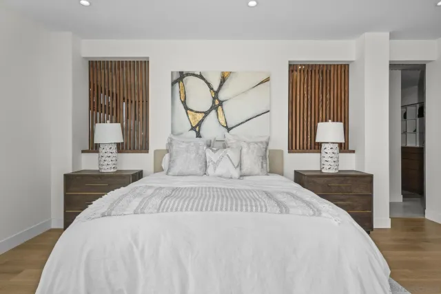 a bedroom with a large bed and a large window