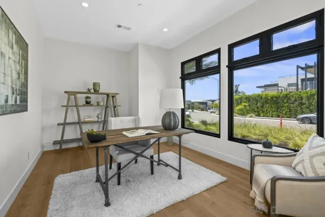 a view of a room with wooden floor and a window