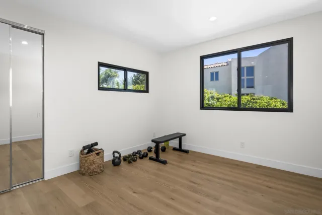 a bedroom with a bed and large window