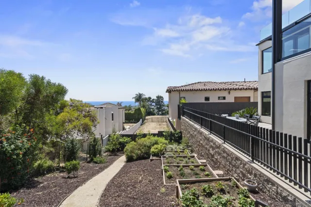 a view of roof deck with couches and sky view