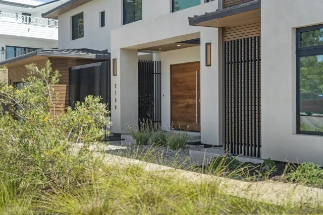 a view of a house with a small yard and plants
