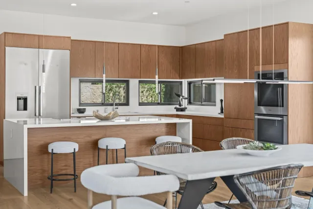 a kitchen with a table chairs stove and kitchen island