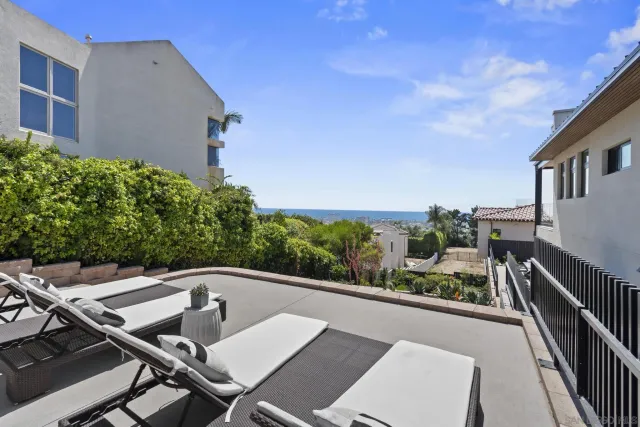 a view of a chairs and table in the balcony