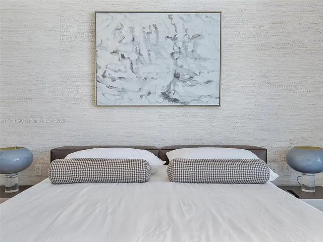 a bedroom with a bed and lamp