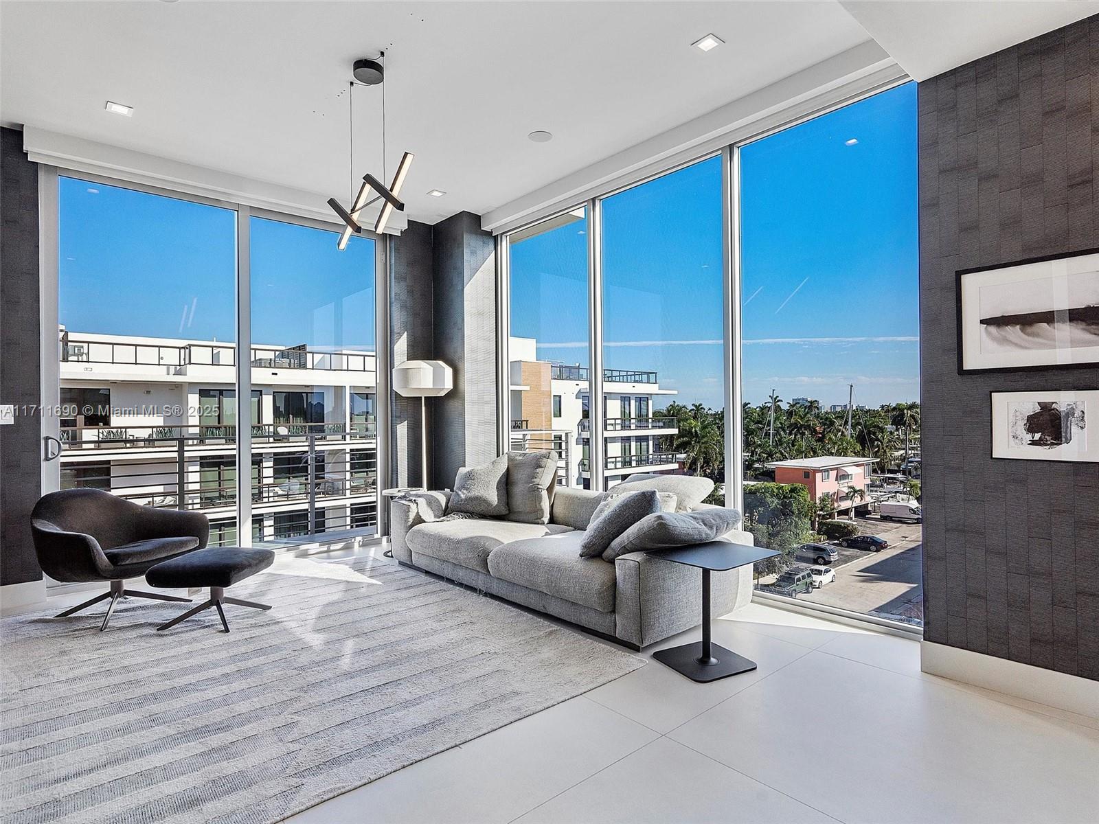 21 Isle Of Venice Drive, Unit PH1 Fort Lauderdale, FL 33301 - Photo 19 of 21 a living room with furniture a window and a kitchen view