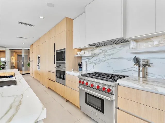 a kitchen with stainless steel appliances a stove a sink and a refrigerator