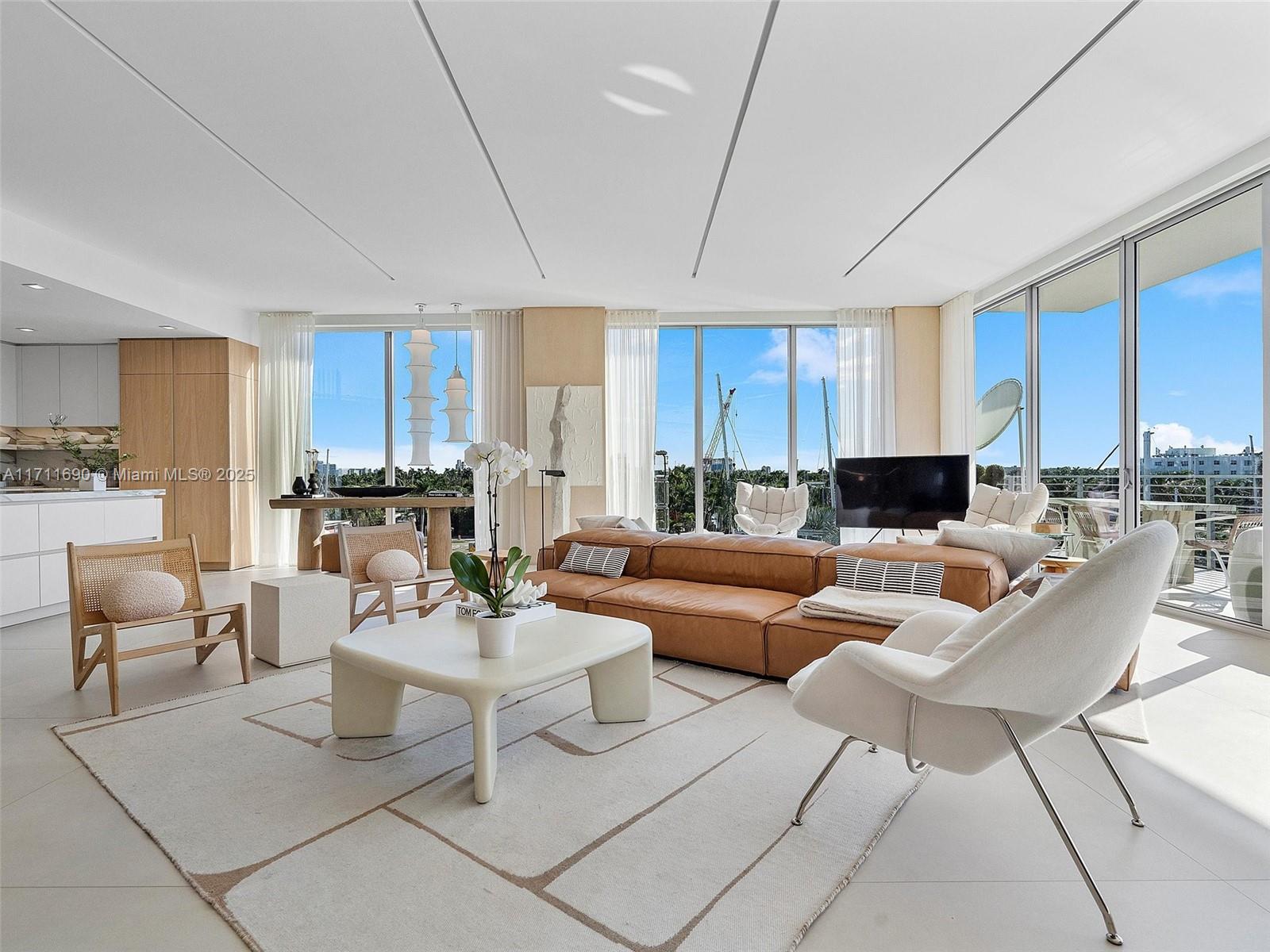 21 Isle Of Venice Drive, Unit PH1 Fort Lauderdale, FL 33301 - Photo 8 of 21 a living room with furniture a kitchen view and a potted plant