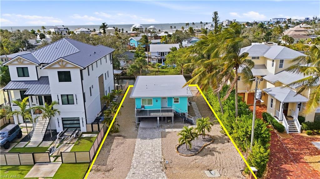 270 Dundee Road Fort Myers Beach, FL 33931 - Photo 41 of 48 Aerial perspective of suburban area with a large body of water - Virtually Edited Image