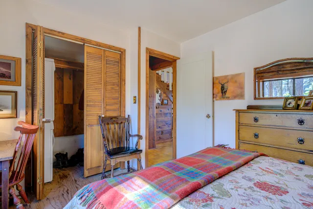 a bedroom with a bed and a table